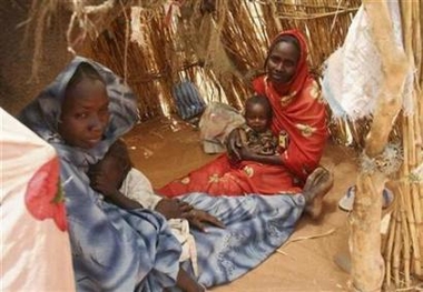 Internally displaced Sudanese women sit inside their make-shift house in their camp near El-Fasher, capital of the north Darfur region, Sudan March 25, 2007

Photo: Michael Kamber/Reuters